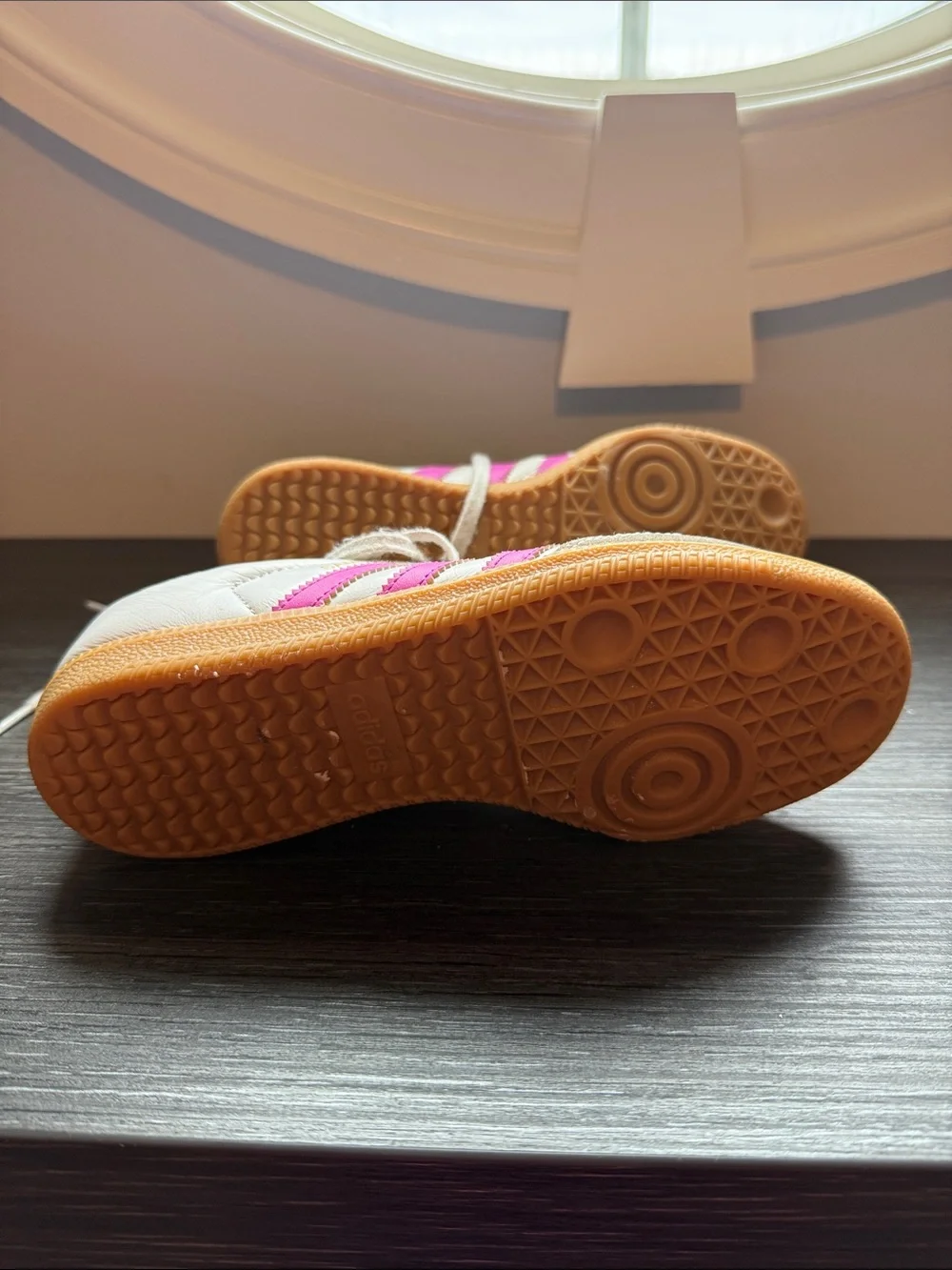 Adidas Samba sneakers in white with bright pink stripes and classic gum sole.
